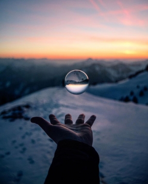 Hand with crystal ball in winter