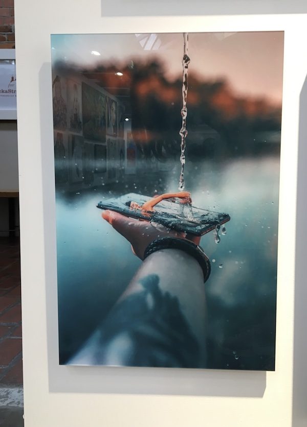 artwork showing a man swimming in a mobile phone