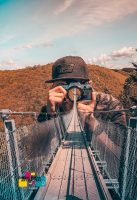 photo of a photographer on a bridge