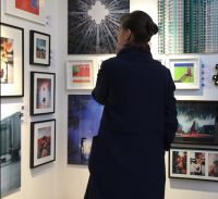 woman looking at photography of social media art gallery