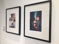 wall with two black framed photos