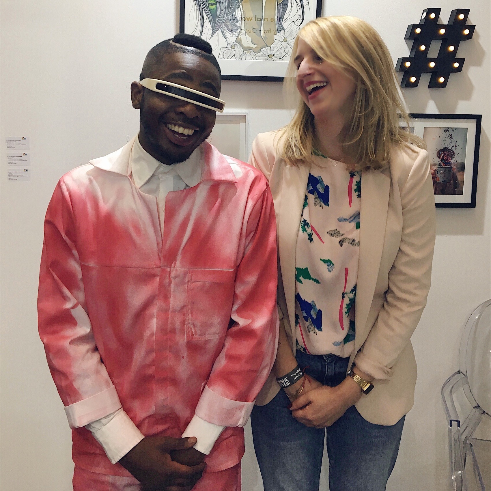 man with a future outfit standing next to social media art gallery owner anna stoffel