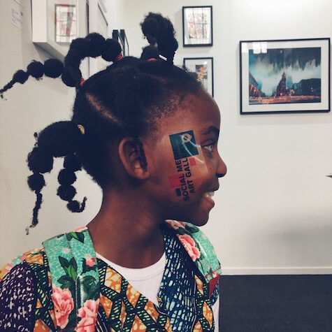 a young girl with social media art gallery sticker in face